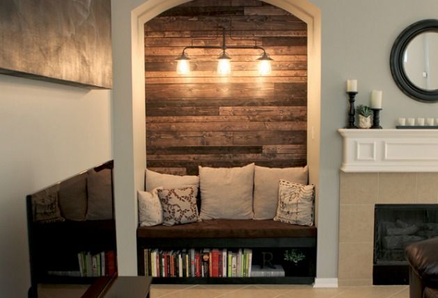 a living room filled with furniture and a fire place in front of a wall mounted fireplace