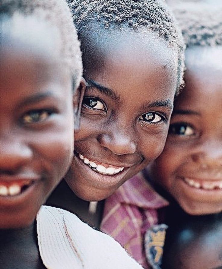 three young children are smiling for the camera