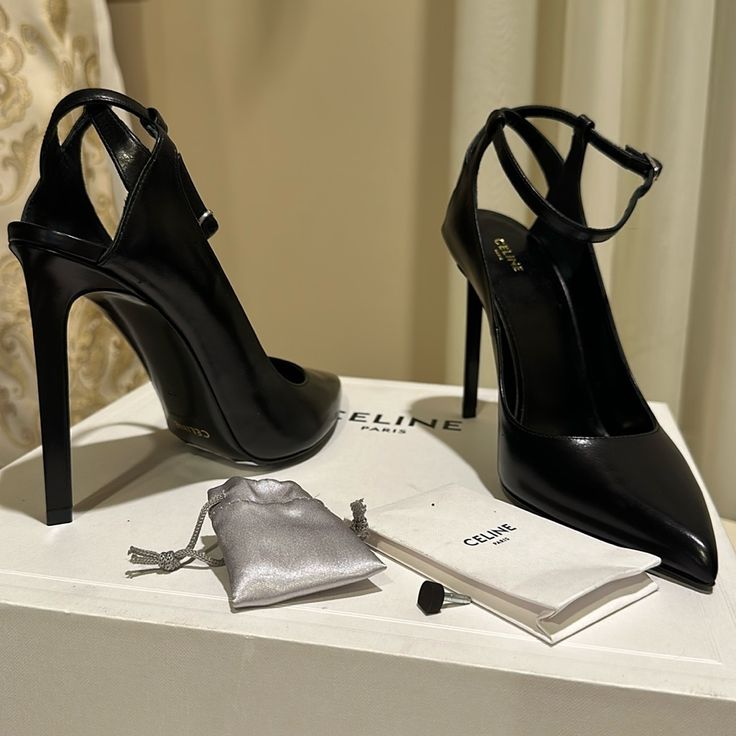 Elevate Your Style With These Stunning Black High Heels By Celine. These Shoes Feature Closed Toe Design With A Buckle Closure For A Secure Fit. The 1-Inch Platform And 4+ Inch Stiletto Heel Add Height And Sophistication To Any Outfit, Making Them Perfect For Any Occasion From Party And Cocktail To Casual And Business. Crafted In Italy With High-Quality Leather, These Classic Heels Showcase A Solid Pattern And Ankle Strap Detail, Making Them A Timeless Addition To Your Shoe Collection. Available Celine High Heels, Model Shoes High Heels, Luxury Court Shoes With 4-inch Heel For Gala, Luxury Evening Court Shoes With 4-inch Heel, Luxury Ankle Strap Heels For Night Out, Luxury Heels With Heel Strap For Office, Luxury Office Heels With Heel Strap, Chic Black Heels For Evening, Luxury Ankle Strap Court Shoes For Evening