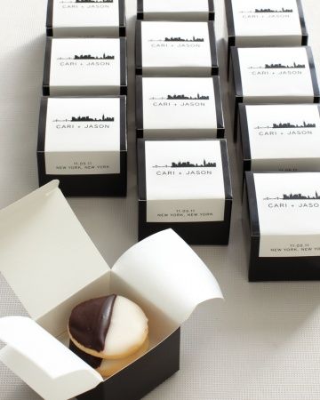 a box filled with chocolate covered donuts on top of a white table next to other boxes