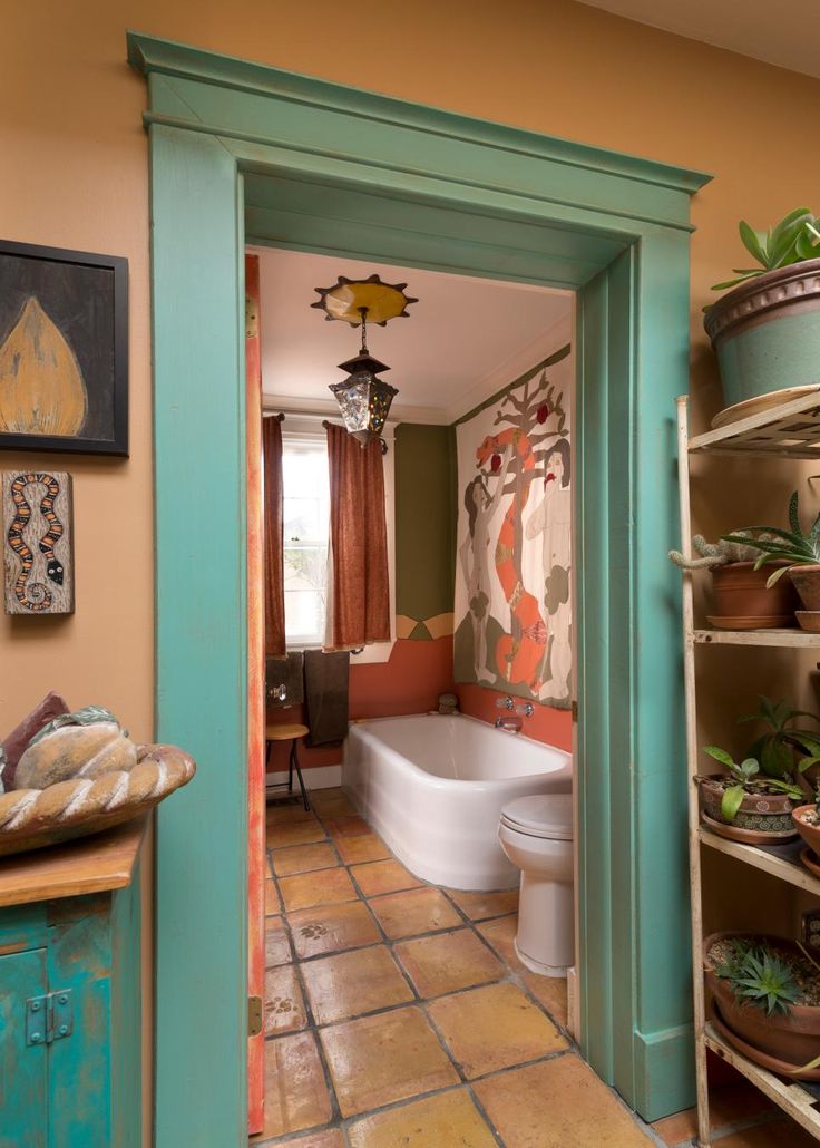 an open door leading to a bathroom with potted plants on the shelves and a tub in the corner