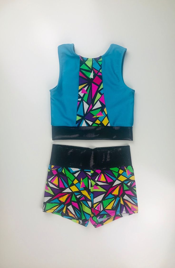 This two piece set includes a sleeveless top and a high-waisted booty short. The top is lined in the front. This set is available in sizes 4-14. Please allow 2-4 weeks for construction and shipping times as all orders are made to order. Fitted Sets With Built-in Shorts, Fitted Multicolor Party Shorts, Summer Fitted Sets With Built-in Shorts, Fitted Sets With Built-in Shorts For Summer, Fitted Sleeveless Tops For Cheerleading, Fitted Multicolor Tops Matching Set, Fitted Blue Matching Set Top, Fitted Multicolor Two-piece Set, Fitted Party Sets Short Length