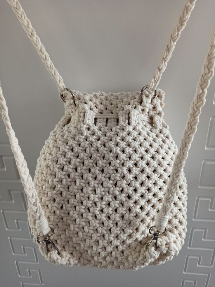 a white crocheted purse hanging from a ceiling