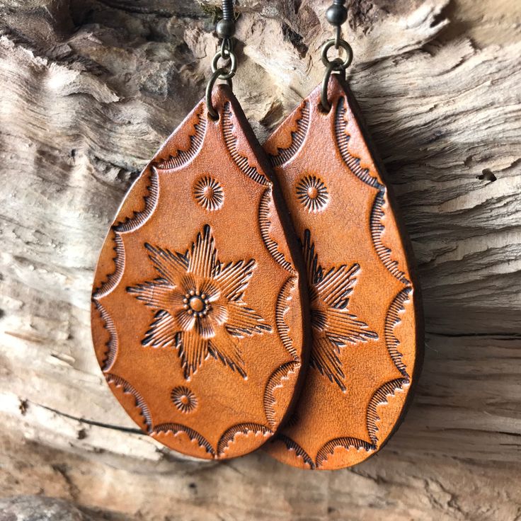 "Hand tooled leather earrings. Premium veg tanned leather. Handmade from start to finish. We love and take great care in what we do and it translates to every detail of your beautiful leather piece. These earrings aren Extra Large at approximately 3\" in length and 1.75\" wide. These are made to order. Hand tooled and dyed in a rich caramel brown with a floral motif and antiqued finish. These look great with any modern boho styles. If you love an extra large statement earring, these are for you! Bohemian Hand-tooled Leather Earrings, Rustic Hand Tooled Leather Earrings, Handmade Rustic Leather Earrings, Handmade Rust Leather Jewelry, Everyday Hand Tooled Leather Jewelry, Everyday Hand-tooled Leather Jewelry, Hand Tooled Leather Earrings As Gift, Hand Tooled Leather Earrings For Gift, Rustic Brown Hand-tooled Earrings