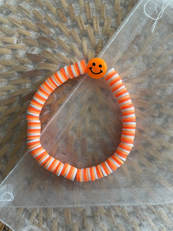 Orange, light orange, and white bracelet Handmade Orange Casual Friendship Bracelet, Casual Handmade Orange Friendship Bracelets, Casual Handmade Orange Friendship Bracelet, Orange Stretch Bracelet With Letter Beads, Casual Orange Jewelry For Friendship, Orange Bracelets With Letter Beads, Playful Orange Beaded Bracelets With Letter Beads, Casual Orange Bracelet For Friendship, Fun Orange Beaded Jewelry