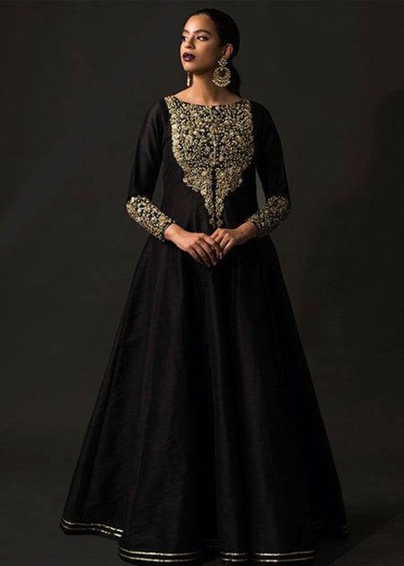 Beautiful black raw silk long anarkali gown has sequin,beads and zari hand embroidery over the neck and sleeves. ✨If you want any changes in the outfit please contact us we will guide you as per your preference. ✨We assure you that we use only high quality fabric and threads to make any dress and you won't face any problem regarding fabric.  ✨We take little longer time to manufacturer the outfit as we made on order and take utmost care while making it so that our customers should be fully satisfied when they receive the dress. Your patience is important.  🌸Care Instructions Dry clean only Black Silk Long Dress, Anarkali Black, Long Dress Indian, Long Anarkali Gown, Long Anarkali, Gown Gold, Fabric Textured, Anarkali Gown, Silk Dress Long