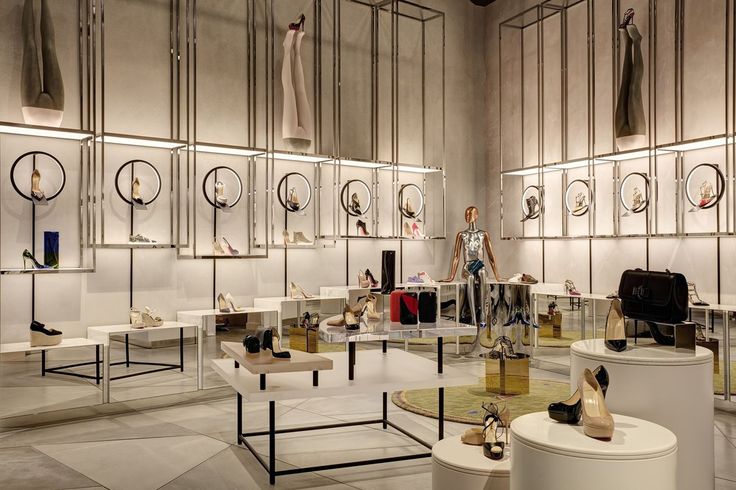 a room filled with mannequins and shoes on display next to each other