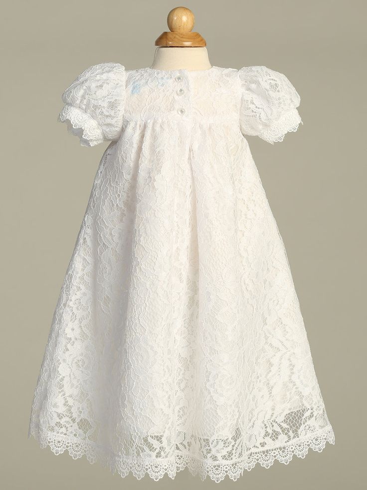 Details This beautiful Victoria lace Christening gown has a rose patterned lace allover. Gown has a high waist accented with satin ribbon and flowers, short puff sleeves and button back closure. Matching lace bonnet. This gown is perfect for a Baptism, Christening, Blessing or any other Special Occasion. Available sizes: X-Small (0-3 months), Small (3-6 months), Medium (6-12 months), Large (12-18 months) Dress: 100% Polyester - Lining: 100% Polyester Hand wash cold. Do not use Bleach. Hang Dry. Elegant Short Sleeve Gown With Lace Bodice, Fitted Short Sleeve Delicate Lace Dress, Fitted Gown With Short Sleeves, Short Sleeve Delicate Lace Dress, Fitted Short Sleeve Lace Dress With Delicate Lace, Delicate Lace Fitted Dress With Short Sleeves, Short Sleeve Lace Dress With Fitted Bodice, Lace Dress With Fitted Bodice And Short Sleeves, Fitted Short Sleeve Lace Dress With Lace Trim