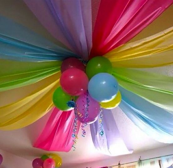 the ceiling is decorated with balloons and streamers