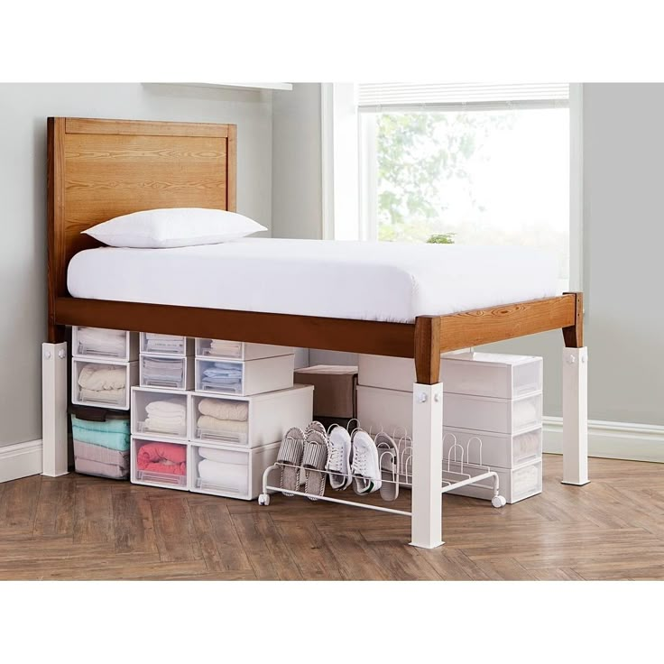 a bed that has some drawers underneath it