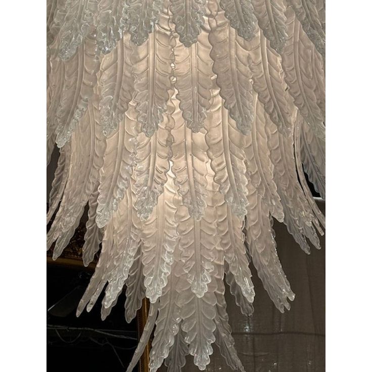 a large chandelier with white feathers hanging from the ceiling