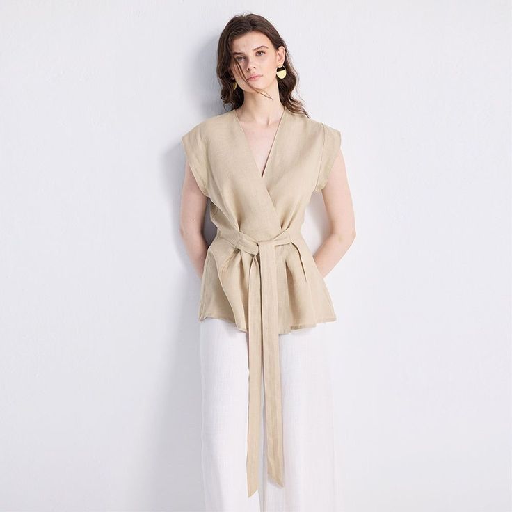 Our Power Moves Top is a wardrobe must-have, your ultimate summer staple! This beautiful wrap top in neutral beige works as well for the office as it does for a dinner with friends. Pair it with sleek trousers or a pair of jeans and see where your day takes you. V-neck Wrap Top With Tie Waist For Work, Elegant V-neck Wrap Top For Work, Beige V-neck Blouse For Office, V-neck Top With Tie Waist For Work, Spring V-neck Khaki Blouse, Spring Khaki V-neck Blouse, Versatile Beige V-neck Blouse, Beige V-neck Top For Office, Chic Taupe V-neck Top