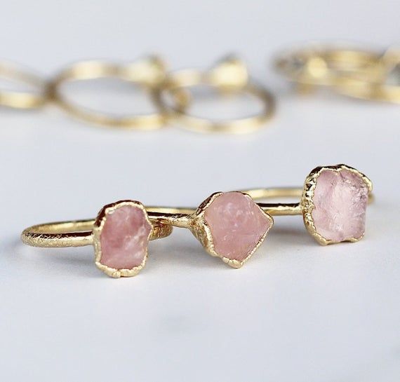 A tiny raw rose quartz crystal is picked with intention and set on a delicate gold band with an organic style setting. ⭐️  Each ring is made by hand and finished with an ultra heavy, nickel free 14k gold plate. Our 14k gold plate is 20 times thicker than most commercial jewelry and intended to last. Stones are about 1/3 inch in size. Please keep in mind that they are natural, so will vary in exact shape, color and size. No two are alike, but all are equally beautiful.Every item purchased arrives Rose Quartz Ring Aesthetic, Rose Quartz Wedding Ring, Raw Rose Quartz Ring, Rose Quartz Rings, Quartz Wedding Ring, Rose Quartz Engagement Ring, Pink Quartz Ring, Rose Quartz Wedding, Rose Quartz Ring Engagement