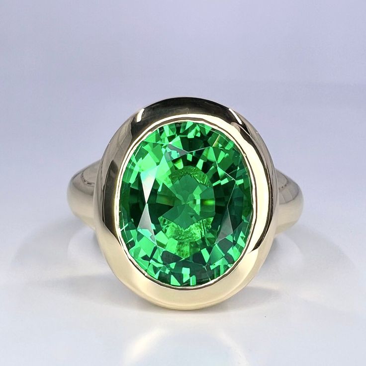 "Oval Emerald Green Mens Engagement Ring Yellow Gold Dome Shape Emerald Men Ring Unique Unisex Emerald Wedding Promise Anniversary Ring This ring is an oval lab created emerald bezel set unisex ring, 14k yellow gold #6304 Emerald is the birthstone of May -Approximate total carat weight:  5.80ctw diamond equivalent  -Center Stone Size:  approx. 5.80ct diamond equivalent -Center Stone Shape: oval 12x10mm -Gem Type:  lab created emerald -Stone Clarity: VS2 -Stone Color: green -Moh's Scale: 8.5 hard Oval Tsavorite Ring With Center Stone, Oval Green Signet Ring For Wedding, Classic Oval Tsavorite Emerald Ring, Classic Oval Green Sapphire Ring, Green Oval Signet Ring For Wedding, Classic Green Sapphire Oval Ring, Oval Emerald Rings With Polished Finish, Classic Green Oval Sapphire Ring, Oval Green Signet Ring For Anniversary