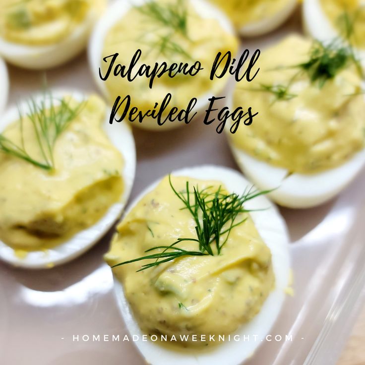 deviled eggs with dill spread on them