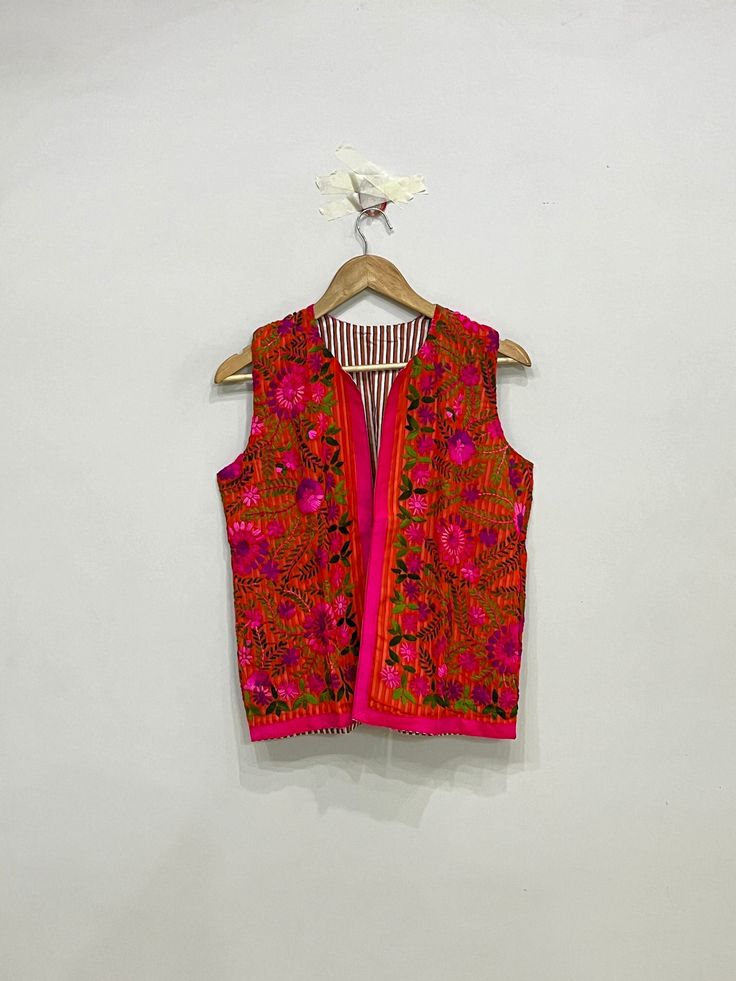 Colorful Sleeveless Phulkari Jacket, Traditional Indian Phulkari Vest, Sleeveless Ethnic Jacket For Women, Gift For Her Product Detail Color:- As Shown In Picture Material:- Fulkari, Embroidered, Cotton Length:- 23inch / 60cm Bust:- 40inch / 102cm Arm Hole:- 10inch / 52cm NOTE : Product color may slightly vary due to photographic lighting sources or your monitor settings. Festive Bohemian Vest With Floral Embroidery, Bohemian Sleeveless Top For Festive Occasions, Traditional Multicolor Sleeveless Choli, Bohemian Handloom Choli, Traditional Multicolor Summer Outerwear, Traditional Sleeveless Cotton Outerwear, Folk Style Multicolor Festival Vest, Traditional Sleeveless Vest For Festive Occasions, Traditional Sleeveless Festive Vest