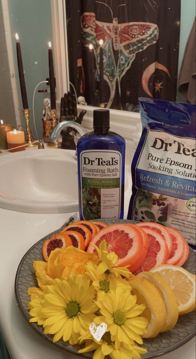 a plate with oranges, lemons and grapefruit on top of a sink