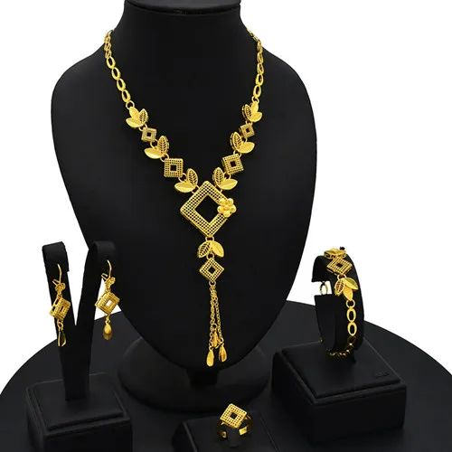 Indulge in luxury with this exquisite Dubai Gold Necklace Set, perfect for wedding parties. With its opulent design and superior craftsmanship, this set features a necklace, bracelet, earrings, and ring. Make a lasting impression and elevate your style with this luxurious jewelry set.' Elegant Alloy Jewelry Sets, Formal Plated Metal Jewelry Sets, Formal Metal Plated Jewelry Sets, Formal Plated Alloy Jewelry, Formal Gold Alloy Jewelry, Formal Jewelry Sets With Plating, Elegant Alloy Jewelry, Metal Jewelry Sets With Clavicle Chain For Weddings, Wedding Jewelry Set With Metal Necklace