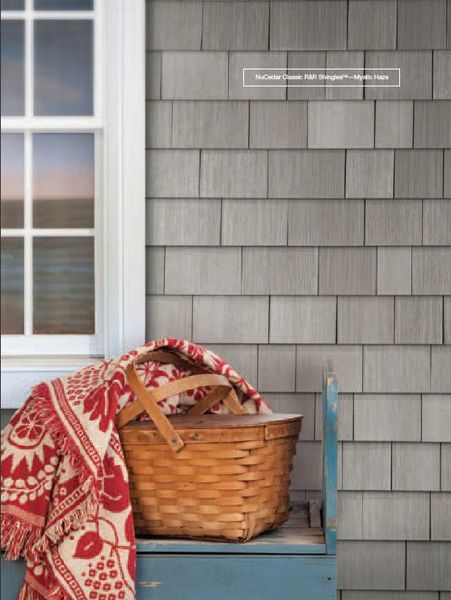 a basket sitting on top of a blue step next to a window with a red and white blanket