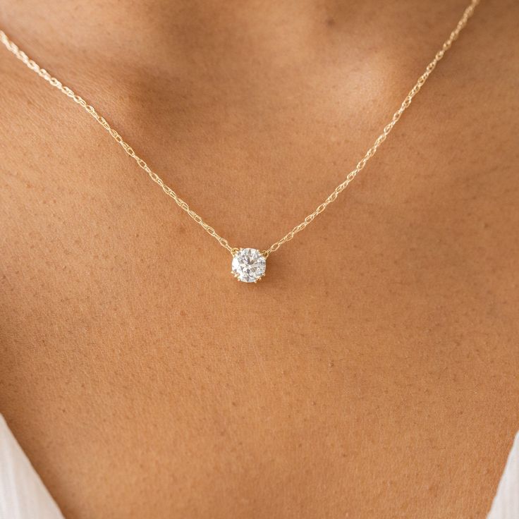 Round cut focal diamond of your choice. Need help choosing a diamond? Our Customer Care team is right here. Solid 14k gold or platinum setting with a delicate rope chain, 18" in total length with a 2" station for shortening— available in platinum or 14k solid yellow, white or rose gold. We handcraft each piece with responsibly sourced 14k gold and ethically sourced stones. Single Diamond Necklace, The Bling Ring, Diamond Pendants Designs, Solitaire Diamond Pendant, Pendant Necklace Simple, Thread Necklace, Diamond Pendant Sets, Diamond Necklace Designs, Floating Necklace