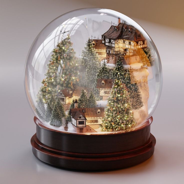 a snow globe with christmas trees and houses in the snow on it, sitting on a table