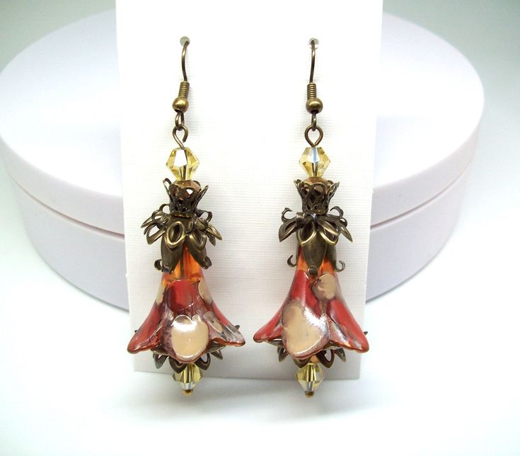 Boho earrings, floral earrings, Dangle & drop earrings. Hand painted, and color sealed (permanent) taupe and sienna orange flower earrings with a splash of canyon brown with light yellow faceted bi-cone crystal accent beads accompanied by a wonderful collaboration of antique bronze elements and findings. Dressed up or down no matter the occasion these elegant flower earrings are sure to compliment you. Earrings are large and long and are lightweight and can be worn comfortably all day long. Plea Orange Flower-shaped Earrings For Gift, Elegant Brown Drop Flower Earrings, Orange Dangle Flower Earrings Gift, Orange Dangle Flower Earrings For Gift, Brown Flower Drop Earrings, Orange Drop Earrings For Gift, Orange Flower Earrings For Gift, Brown Flower Drop Earrings For Gift, Brown Drop Flower Earrings For Gift