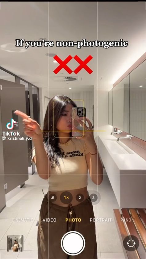 a woman is taking a selfie in the bathroom