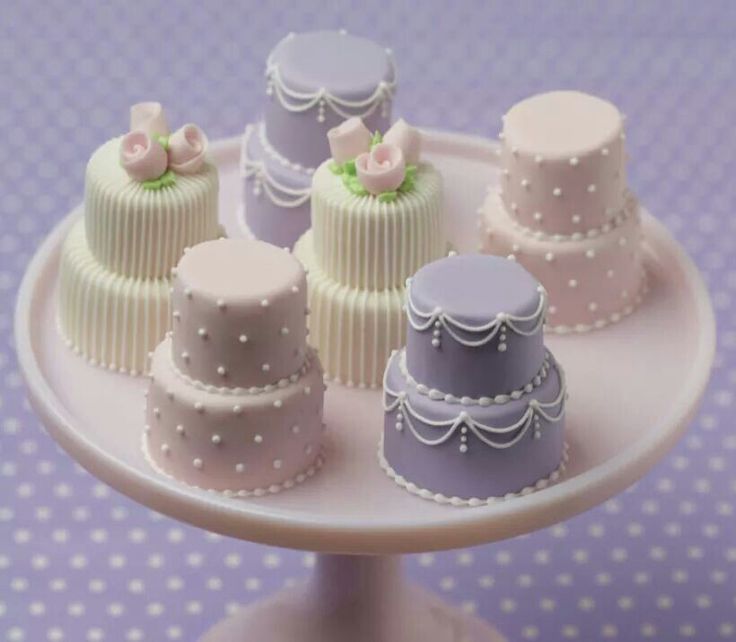 there are many small cakes on the cake plate