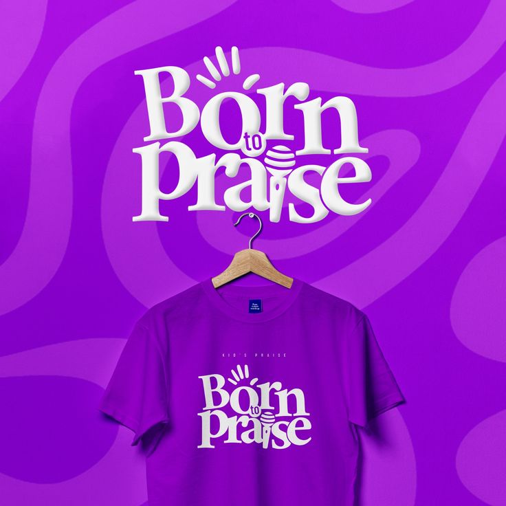 a purple t - shirt with the words born to praise hanging on a hanger