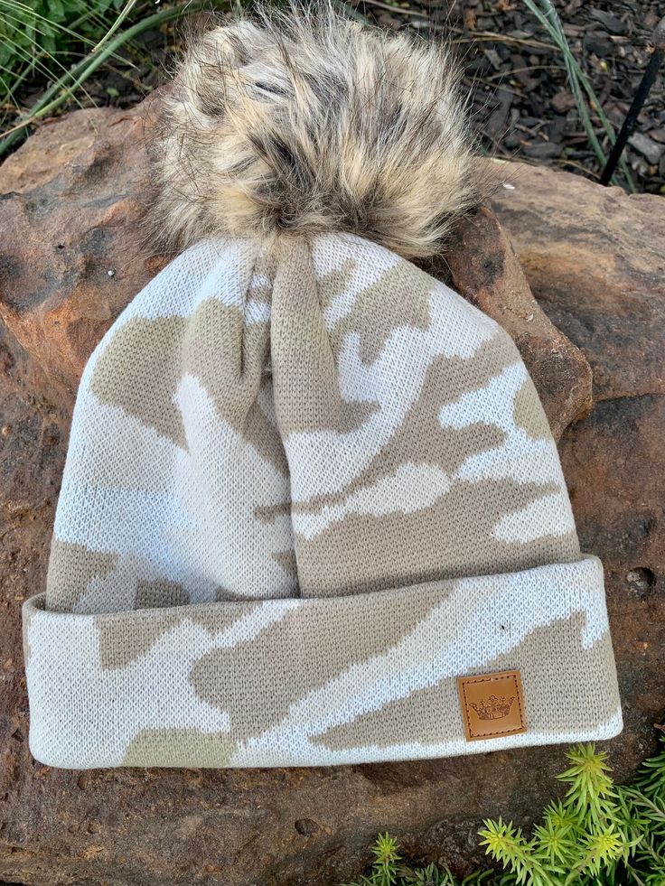 Cream toned camo beanie with a natural puff on top fleece lined made by Panache Accessories Brown Military Hat For Winter, Khaki Winter Hats, Khaki Hats For Outdoor Fall Use, Khaki Outdoor Hat For Fall, Fall Outdoor Khaki Hat, Cream Hat For Fall Outdoor Events, Cream Hat For Outdoor Fall Events, Cream Hats For Outdoor Fall Events, Cream Fall Outdoor Hat