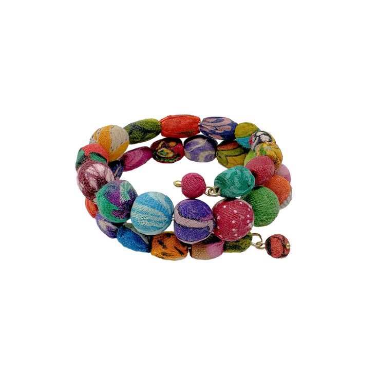 Oval, elongated, and round Kantha beads graduate towards the center as they wind around a memory wire base to create this colorful wrap bracelet. Measures approximately 0.75” tall, it adjusts to fit most. It’s crafted from repurposed Sari and Kantha textiles so exact colors and patterns will vary. Sustainably handmade by women artisans in India. Adjustable Multicolor Artisan Wrap Bracelet, Artisan Beaded Multicolor Wrap Bracelet, Artisan Multicolor Beaded Wrap Bracelet, Multicolor Bangle Wrap Bracelet For Friendship, Eclectic Multicolor Beaded Bracelets With Wooden Beads, Artisan Multicolor Wrap Bracelet For Festival, Eclectic Multicolor Hand Wrapped Bracelets, Eclectic Multicolor Wooden Beaded Bracelets, Artisan Multi-strand Multicolor Beaded Bracelets