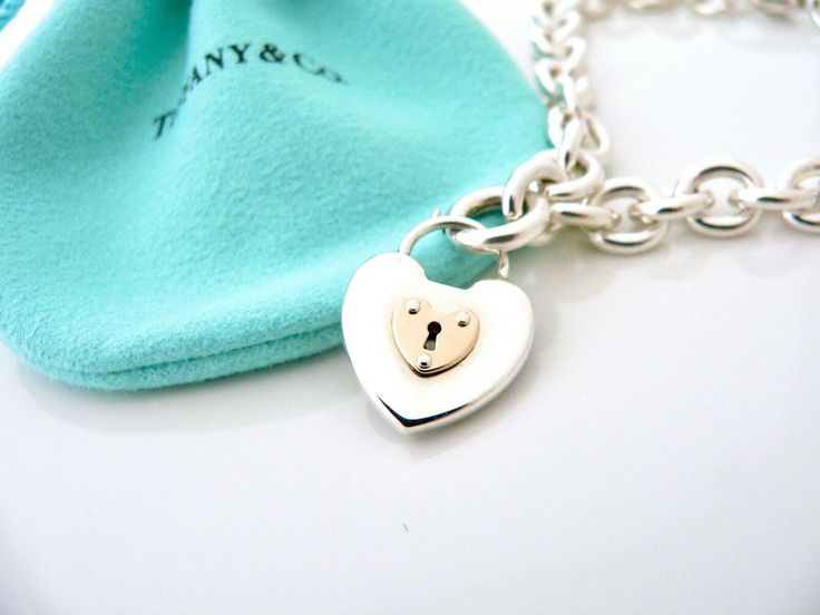 Offered for sale is a wonderful and super pretty Tiffany and Co. Sterling Silver 18K Gold Heart Key Hole Charm bracelet. The piece is made from substantial and bright Tiffany silver, and yet retains a very feminine feel to it. Attached to its very substantial and bright Tiffany Silver charm bracelet is a super pretty Heart Key Hole charm! The Heart charm has a Tiffany & Co circle clasp that opens and closes, and thus can be used as a charm on a necklace or as part of another charm bracelet! Supe Pretty Heart, Rare Gifts, Heart Key, Tiffany Jewelry, Heart And Key, Bracelet Chain, Gift Love, Silver Charm Bracelet, Tiffany And Co