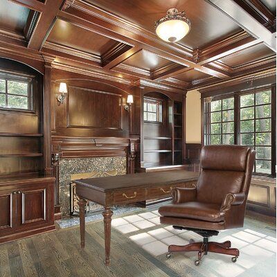 an office with wood paneling and leather chair