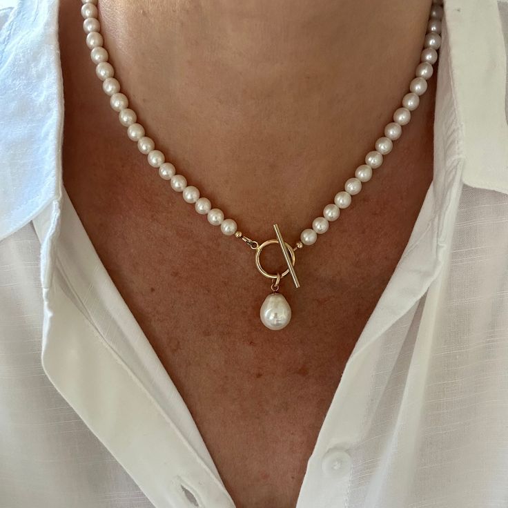 This classic white pearl necklace features a gorgeous 12x15mm smooth teardrop white freshwater pearl that drops elegantly from the gold filled toggle clasp. The necklace is made with 6mm high quality genuine AAA grade natural round freshwater pearls that have high luster and luminescence. These natural pearls have a superior polish, are perfectly calibrated, and are uniform in size.  - Not dyed, treated or color enhanced. 100% natural. - Photos taken outside in natural lighting and in a light bo Tear Drop Pendant, Freshwater Pearl Jewelry, Necklace Extender, Big Pearl, White Pearl Necklace, Drop Pendant Necklace, Classy Fashion, Natural Lighting, White Freshwater Pearl