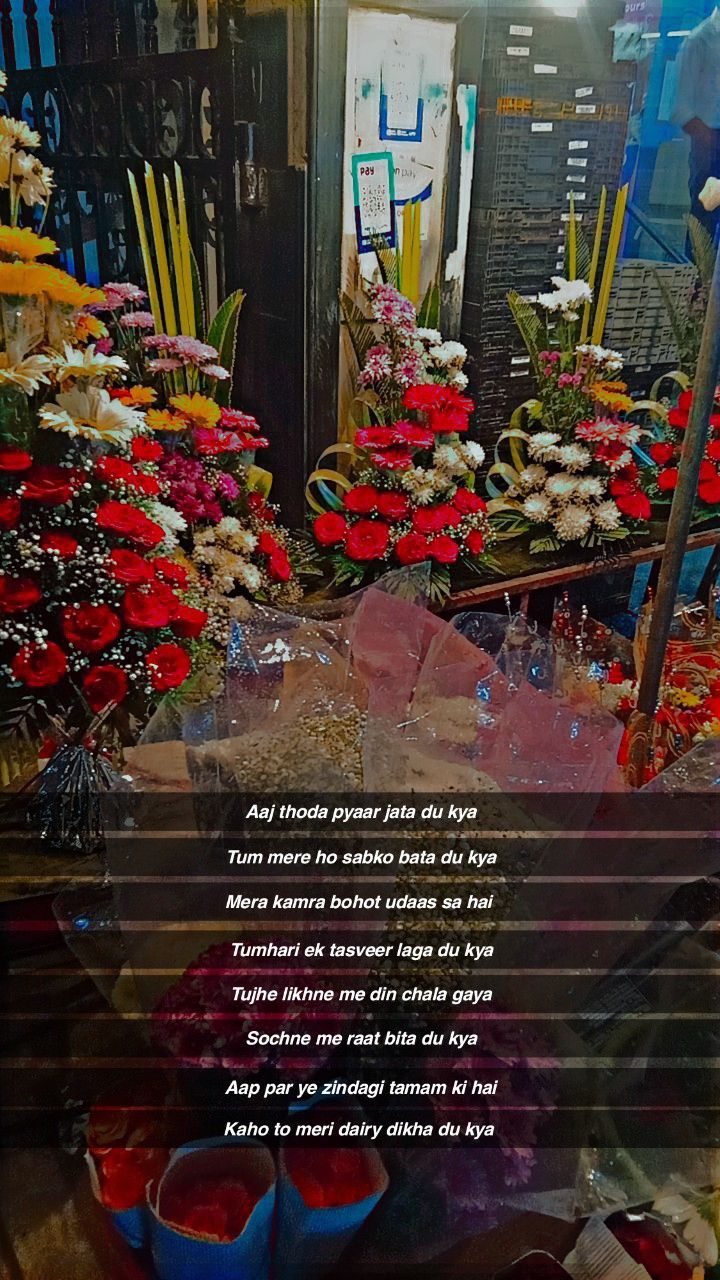 flowers and candles are on display in a store window with the words written below them