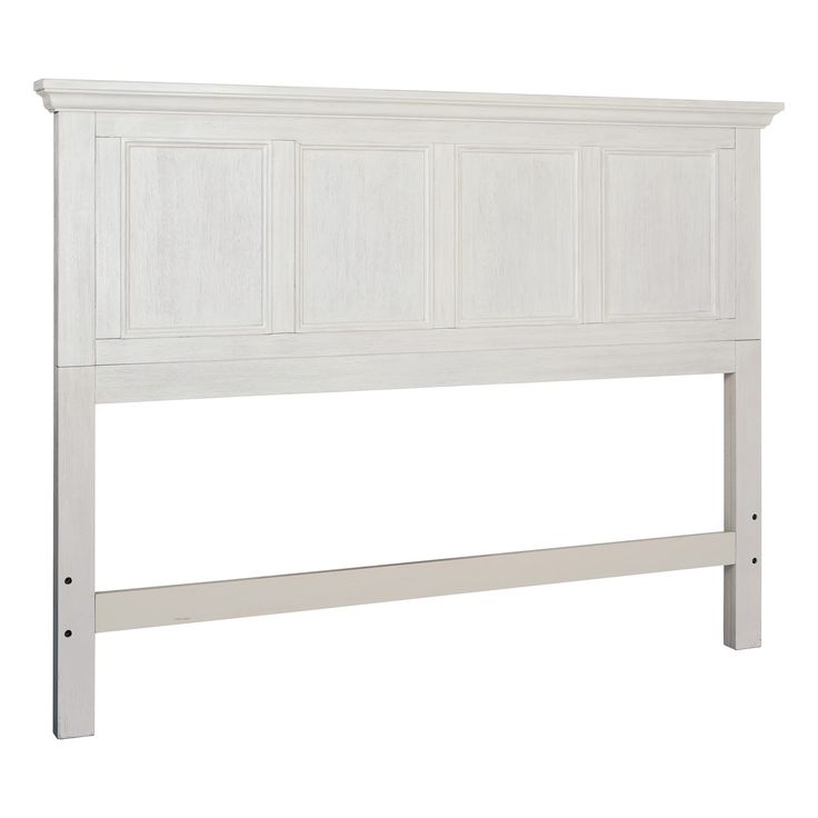 a white headboard with wooden paneling on the top and bottom part of it