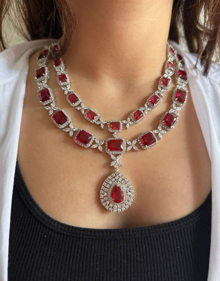 Stunning AAA cubic zirconia Lab Ruby and diamond necklace. Real looking. Necklace length adjustable Earrings length: 2.2 inches approx AAA quality cubic zirconium used. Highest quality and craftsmanship. This set will surely make heads turn .. Finest Cz work . Customized orders takes 3 to 4 weeks, depending on piece requirements. The Ombre Designs Jewelry pieces can be customized in accordance with your requirement. Please Email or Whats app on : +91 8448833193 / sonalikamehra@ theombredesigns.c Large Ruby Necklace, Big Ruby Necklace, Black Dress Jewelry Ideas, Red Diamond Necklace, Diamond Ruby Necklace, Long Diamond Necklace, Red Ruby Necklace, Red Necklace Set, Ruby Necklace Designs