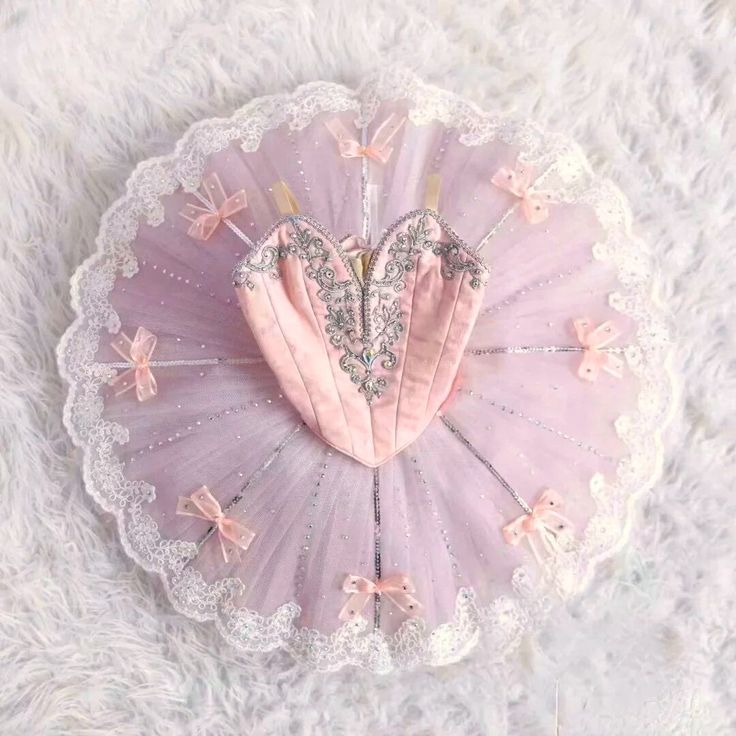 a pink heart shaped pillow sitting on top of a white furnishce covered floor