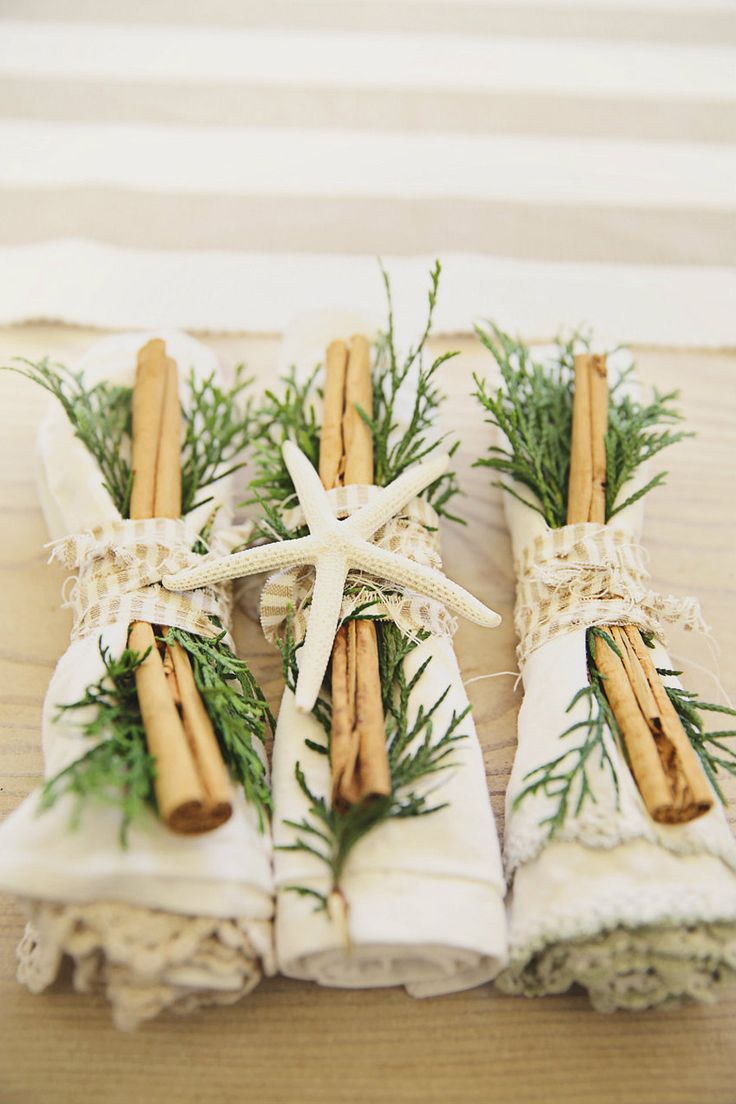 cinnamon sticks wrapped in twine and tied to burlocks with rosemary on them