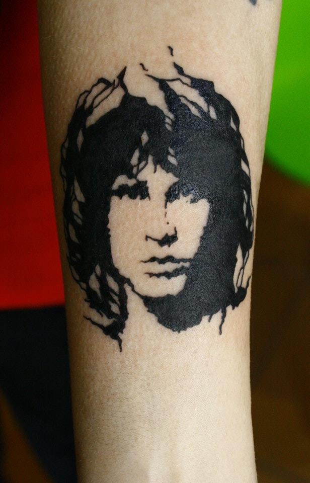 a person with a tattoo on their leg that has a woman's face painted on it