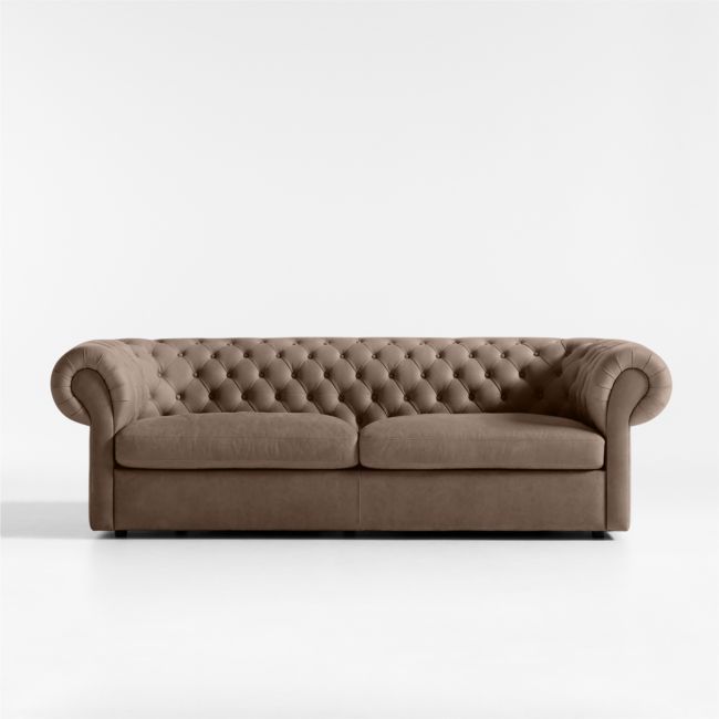 a brown couch sitting on top of a white floor