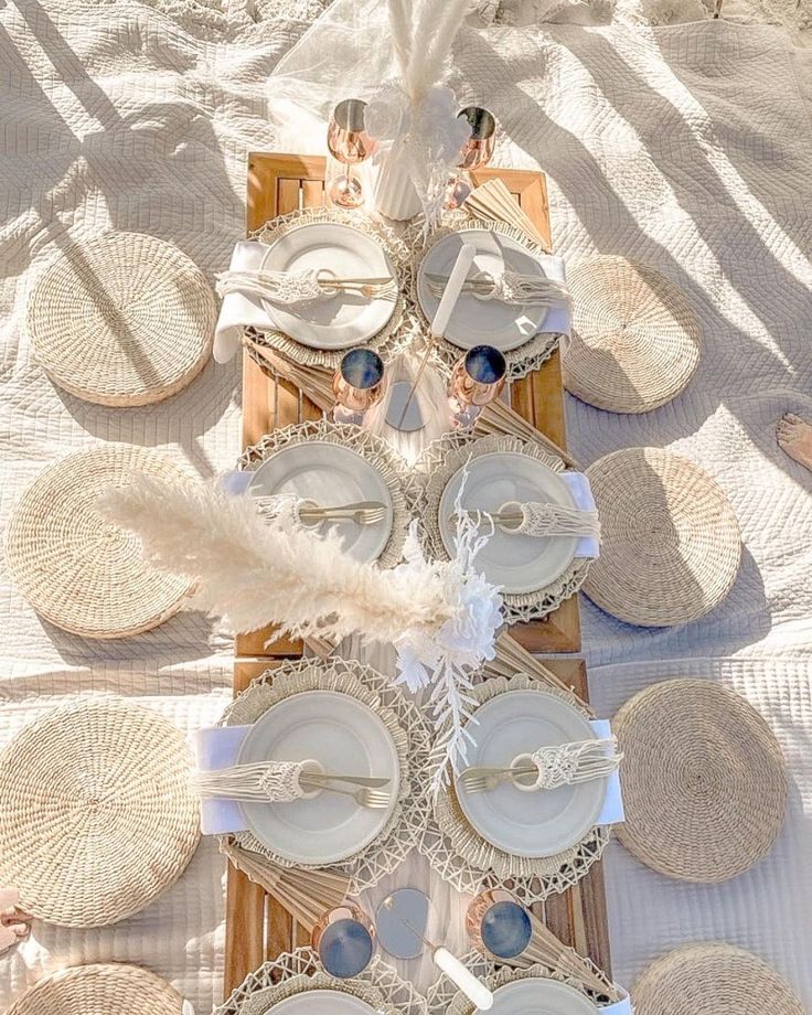 the table is set with white plates and silverware