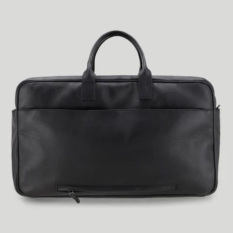 Canary is the ideal travel bag. Not only does the black aniline leather bag match with any business outfit, it also has enough storage for your business trips. Your most valuable items are safely packed in the large main compartment equipped with a double zipper for easy access and an additional front pocket with a magnetic button for even more space. For quick organization there are also some card slots and a phone or passport pocket in the main compartment of the bag. The laptop charger and mo Leather Business Travel Bag With Luggage Sleeve, Business Travel Bag With Luggage Sleeve In Leather, Classic Black Soft Leather Travel Bag, Classic Black Leather Work Backpack, Leather Weekender Bag With Luggage Sleeve For Business, Classic Satchel Luggage For Business Trips, Classic Leather Travel Bag For Business Trips, Classic Weekender Bag For Business Trips, Modern Leather Travel Bag For Business Trips