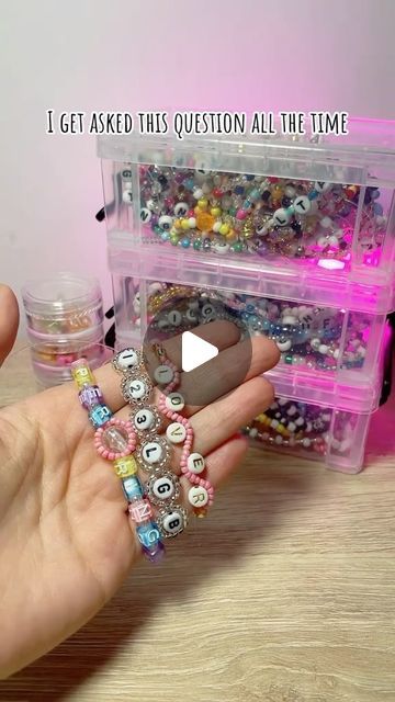 a person holding a plastic container filled with lots of different colored beads and beading