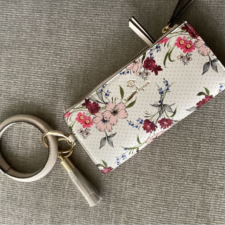 a keychain with a flower print on it sitting next to a pair of scissors