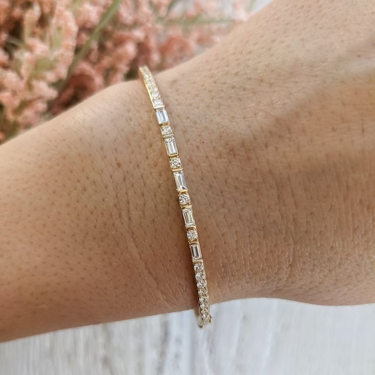 Our Toryn baguette round alternating diamond bracelet is available in lab grown and natural diamonds and can be customized with larger diamonds or different gemstones. Contact us for a quote on any customization to get started on a custom order: http://etsy.me/1231fkN Details: - Made in New York, USA. - Bracelet is 7 inches in length, and 2.3mm wide. Contact us for different dimensions. - Choose between lab grown (VS+F) or Natural diamonds (VS+G) - Approximate carat weight is 1 carat. - High pol Yellow Gold Diamond Bracelet With Baguette Diamonds, Yellow Gold Diamond Bracelet With Baguette Cut, Timeless Yellow Gold Diamond Bracelet With Baguette Diamonds, 14k Yellow Gold Diamond Bracelet With Baguette Cut, Yellow Gold Baguette Diamond Bracelet Gift, Usa Bracelet, Diamond Bangles Bracelet, Cvd Diamond, Types Of Diamonds