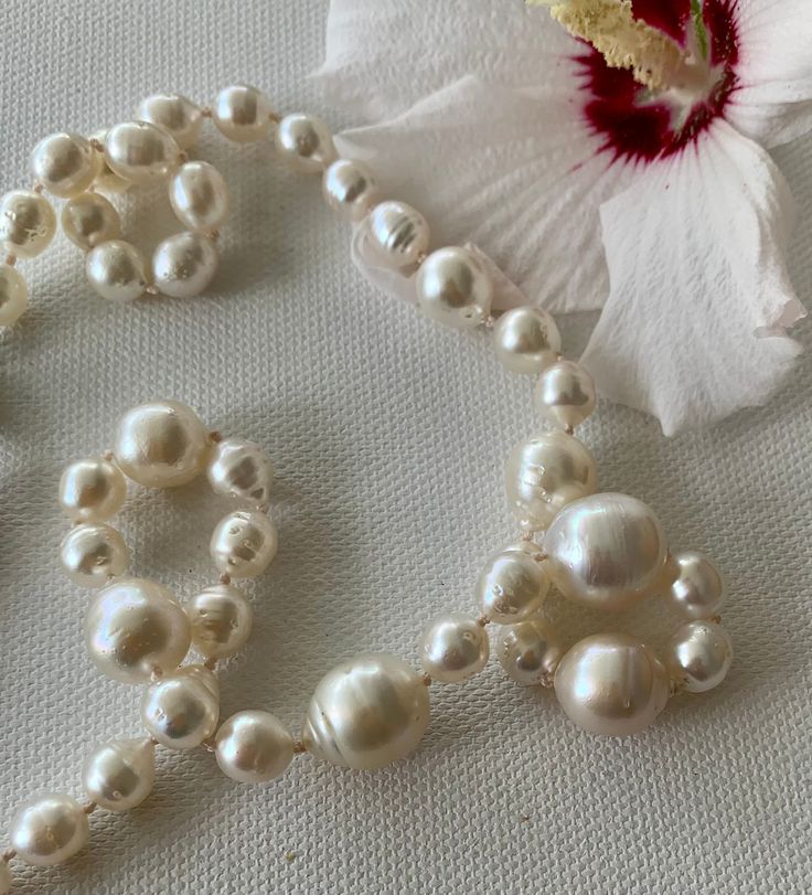 "These pearls are lustrous and glowing baroque, white genuine South Seas pearls. They range from 7.5 mm to 15.2 mm in size (example measurements in photos). I designed this to have waves of pearls, small to large. The clasp is silver and fishhook style, for a total length of 20.25\". Please note there are natural blemishes on these pearls." Formal Baroque Pearl Necklace With Pearl Charm, Formal Baroque Pearl Necklace With Charm, Baroque Pearl Drop Necklace For Formal Occasions, Formal Baroque Pearl Drop Necklace, Luxury Pearl White Pearl Necklace, Luxury High Luster White Pearl Necklace, Luxury White Pear-shaped Pearl Necklace, Formal Baroque Pearl Necklace With Round Beads, Classic Baroque Pearl Necklace With High Luster