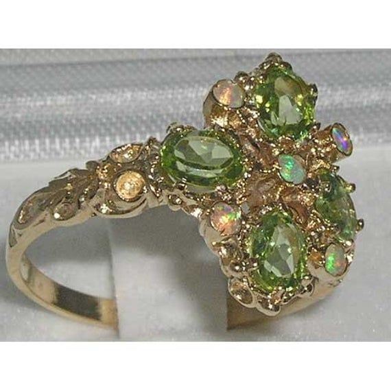 *This unique ring is made from Solid 9K Yellow Gold with Genuine Precious Peridots and colorful Opals.*Total Height 4mm, Width 15mm, Length 17mm This Unique ring is Handcrafted from Solid English 9K Yellow Gold, Handset with exquisite precious gemstones and fully tested and Hallmarked by the London Assay Office, giving you the assurance of a high quality timeless piece.This impressive ring is handset Natural Peridots & Opals - Four Oval cut 5x4mm (0.20" x 0.16" inches) Natural Peridots and f Green Cluster Multi-stone Rings, Luxury Cluster Multi-stone Green Rings, Green 14k Gold Cluster Ring, Green Cluster Multi-stone Jewelry, 14k Gold Green Multi-stone Cluster Ring, Green Cluster Rings In 14k Gold, Green Multi-stone Marquise Jewelry, Gold Cluster Rings With Gemstone Accents, Heirloom Green Cluster Ring