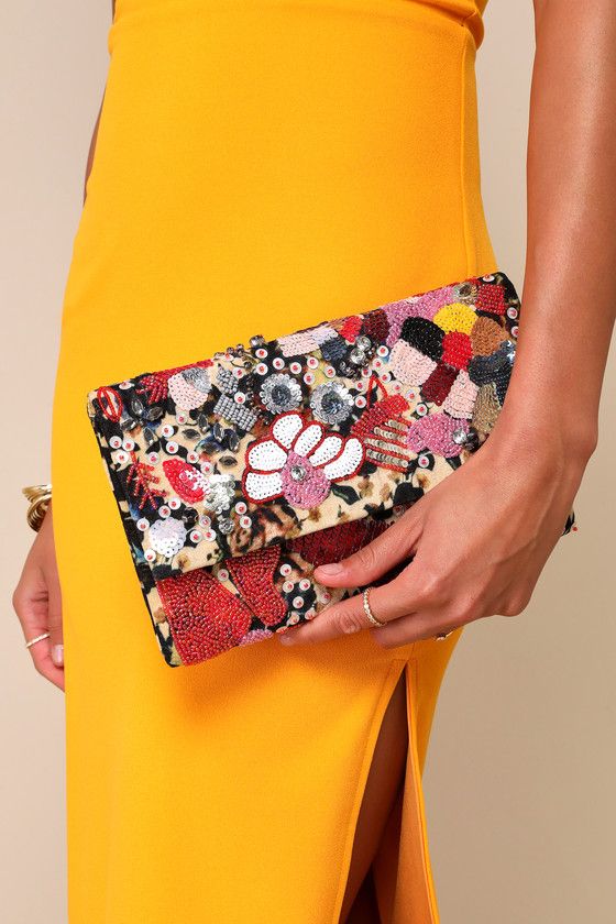 The Lulus Earthly Gardens Beige Multi Beaded Clutch is a fashion statement! Woven soft fabric, in a beige, black, and yellow floral print forms this unique clutch embellished with shiny sequins, beads, and rhinestones in pink, white, red, silver, and orange hues. Open the magnetic closures to reveal a structured interior with a sidewall pocket. Carry as a clutch or attach the matching gold snake chain strap. Patterns may very. Lined. Clutch Measures 9. 5" Wide, 6" Tall, And 0. 5" Deep. Detachabl Summer Beige Clutch For Party, Summer Party Beige Clutch, Summer Embellished Rectangular Clutch, Embellished Clutch For Summer Evenings, Chic Beige Embellished Clutch, Spring Party Clutch, Rectangular Shape, Spring Party Clutch Rectangular Shape, Spring Party Rectangular Clutch, Summer Party Embellished Clutch