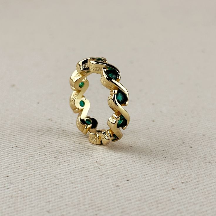 Indulge in the modern and intricate design of our 18k Gold Filled colored CZ Wave Eternity Band Ring. With its sparkling details, this ring is bound to add a touch of elegance and sophistication to any outfit. A must-have for those who appreciate timeless beauty and exquisite style. Now available in two trendy colors Emerald Green and Black Onyx. Metal: 18k Gold filled Colors Sold separately Hypoallergenic Water-resistant Handcrafted in Brazil Note: Due to the handmade nature of this item sizes Emerald Eternity Band In Yellow Gold As Gift, Elegant Yellow Gold Eternity Band With Gemstone, Yellow Gold Emerald Eternity Band As A Gift, Gold Gemstone Eternity Band For Formal Occasions, Gold Eternity Band With Gemstone For Formal Occasions, Formal Gold Eternity Band With Gemstones, Elegant Yellow Gold Infinity Eternity Band, Elegant Infinity Eternity Band As A Gift, Elegant Emerald Eternity Band With Prong Setting